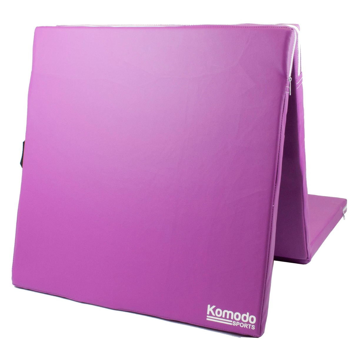 Purple Komodo tri folding impact absorbing mat folded with built-in handles for easy carrying and storage on white background
